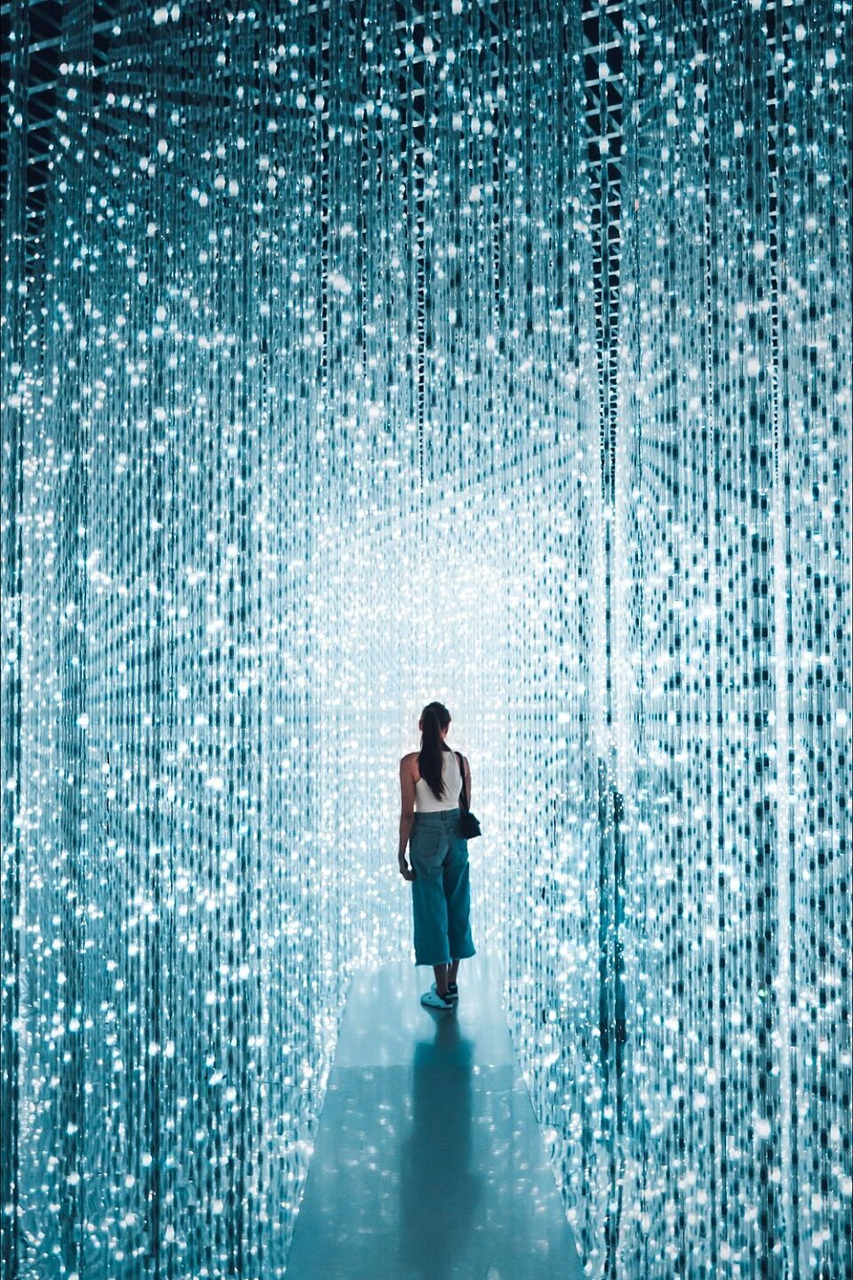 Person is standing in the middle of a room with blue lights